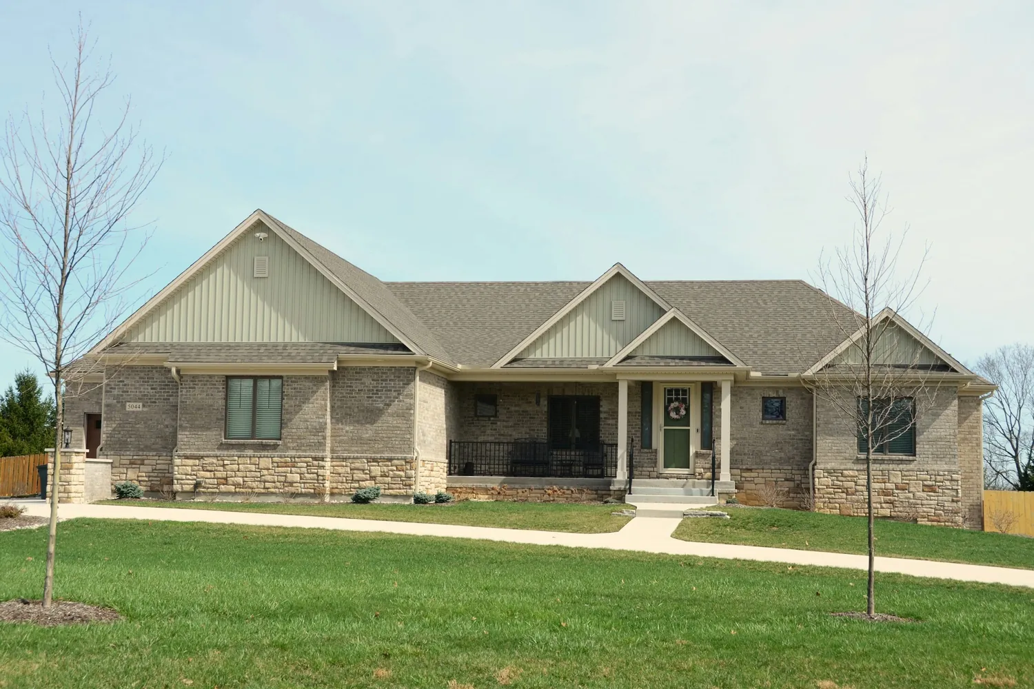 Brick and stone single-family home with a covered front porch