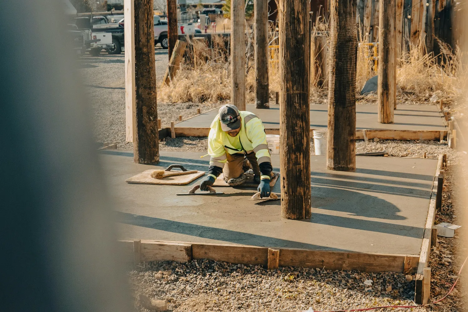 Worker finishing a fresh concrete slab