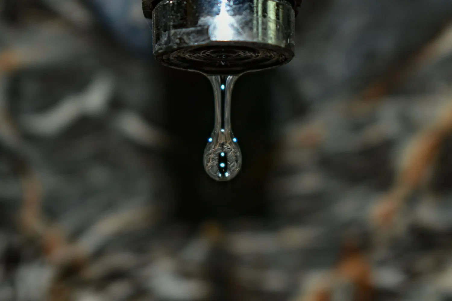 Close-up of a drop of water falling from a faucet