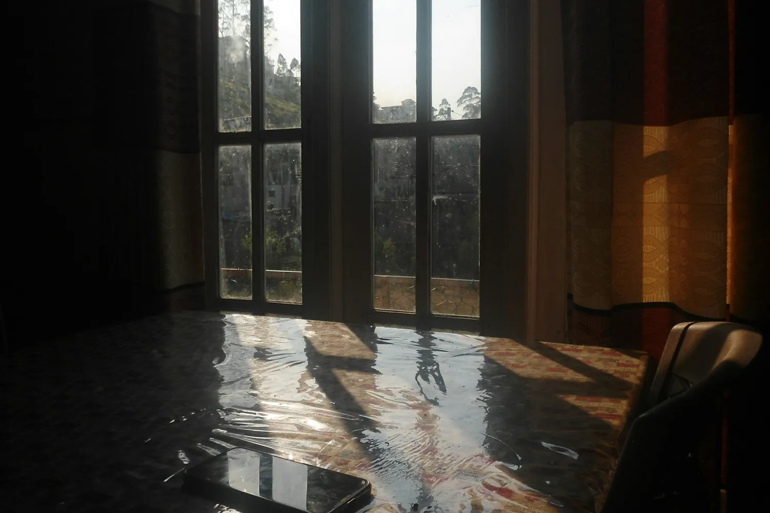 Standing water on a floor reflecting light from a window